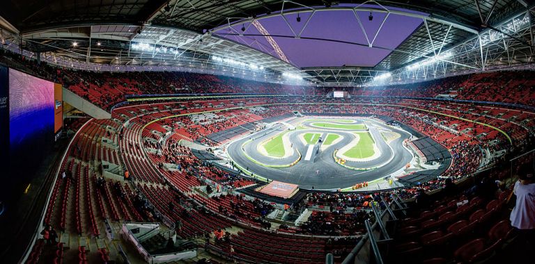 Wembley Stadium. Built on the remains of a folly (definitely), and a steam locomotive (possibly). By E01 from London, UK (Race of Champions at Wembley Stadium panorama) [CC-BY-SA-2.0], via Wikimedia Commons