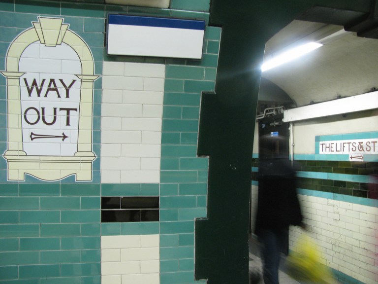 Signage in the passageways at Russell Square station, London, UK. By Emerson Povey [CC BY] via this flickr page.