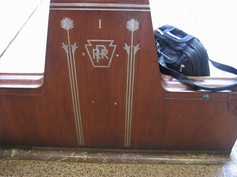 Detail of bench in the waiting room at Penn Station. Photo bRickyrab at the English language Wikipedia [GFDL or CC-BY-SA-3.0], via Wikimedia Commons