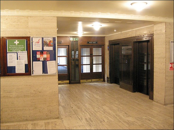 One of the lobbies at 55 Broadway, with splendid period details. Note in particular the wooden doors with bronze fittings, and the decorative coving. Photo by Hornet Arts [CC BY 2.0] via this flickr page