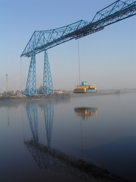The Tees Transport Bridge's gondola crosses the River Tees. Photo by Lynn Pearson [CC BY 2.0] via this flickr page