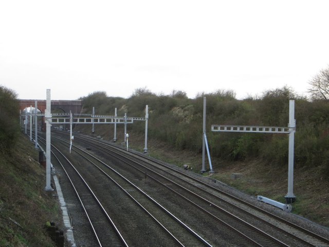View of electrification gantries awaiting completion on the Great Western Main Line in the cutting between Moulsford Bridge & Sill Bridge in Cholsey. Progress is being made, but more slowly than planned. © Copyright Bill Nicholls and licensed for reuse under this Creative Commons Licence