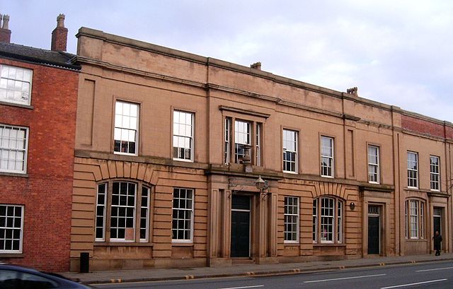 Liverpool Manchester Road station. Most of the building seen here is the First Class booking hall. At the far right is the Second Class booking hall. By Pit-yacker (Own work) [GFDL or CC-BY-SA-3.0], via Wikimedia Commons