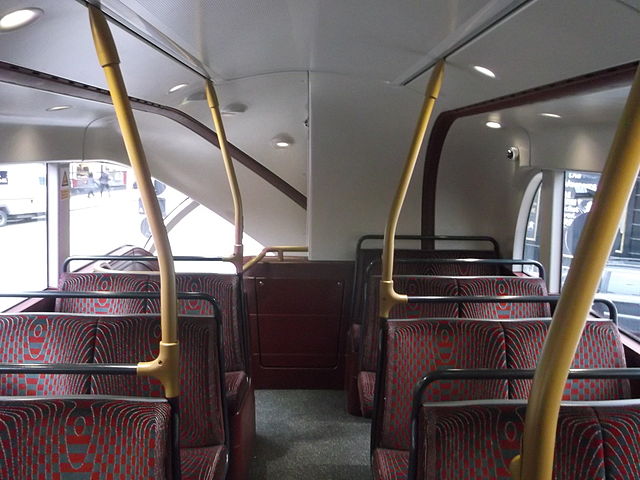 The upper deck of a New Routemaster, looking towards the rear. The back seat on the right is the worst offender in terms of headroom and ability to see out of the bus. David Anstiss [CC BY-SA 2.0], via Wikimedia Commons